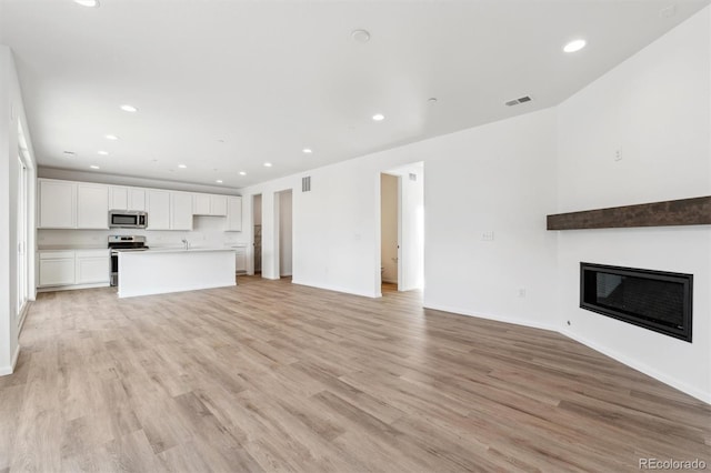 unfurnished living room featuring light hardwood / wood-style floors