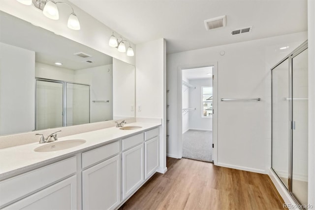 bathroom featuring vanity, hardwood / wood-style floors, and an enclosed shower