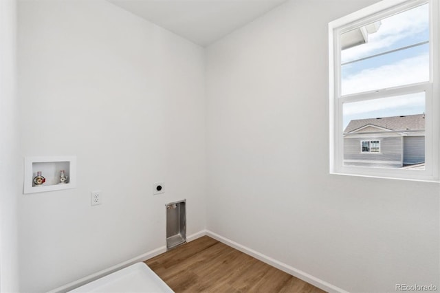 laundry room featuring electric dryer hookup, hookup for a washing machine, and hardwood / wood-style flooring