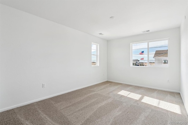 unfurnished room featuring carpet