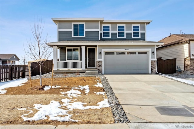 view of front property with a porch and a garage