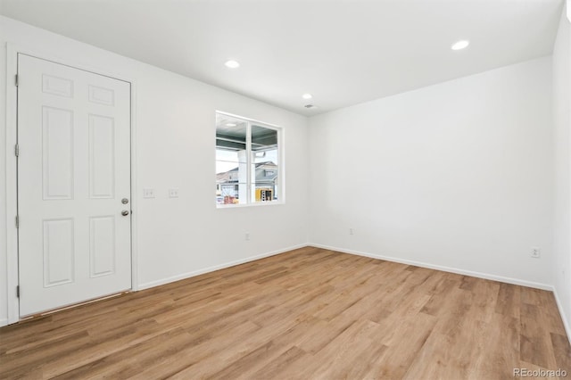 spare room featuring light wood-type flooring