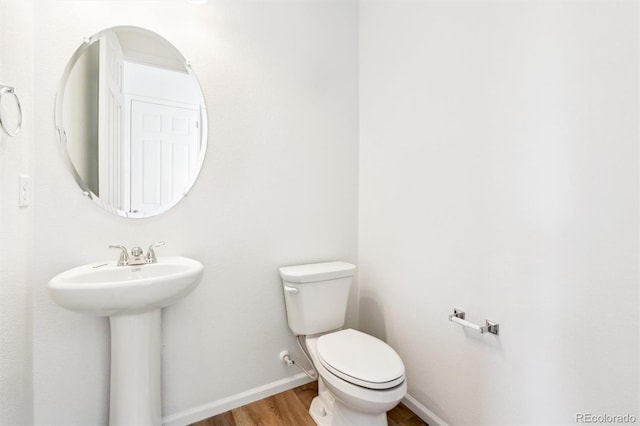 bathroom with sink, wood-type flooring, and toilet