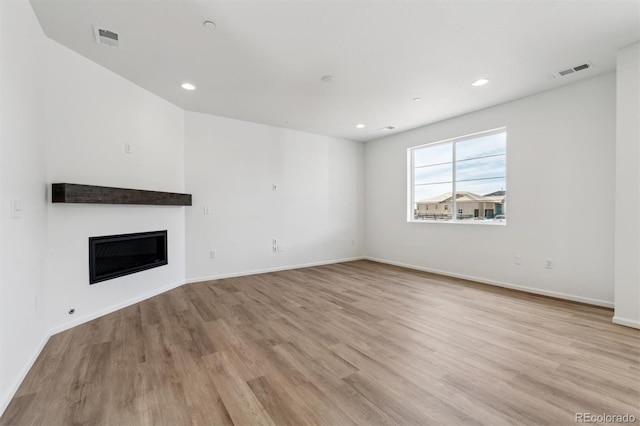 unfurnished living room with light wood-type flooring