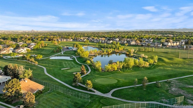 aerial view of residential area with a large body of water and a golf course