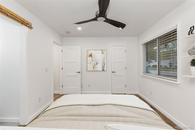 bedroom featuring baseboards and ceiling fan