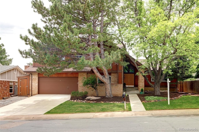 10572 E Orchard Pl, Englewood, CO 80111 - view of front facade with brick siding, concrete driveway, and a garage