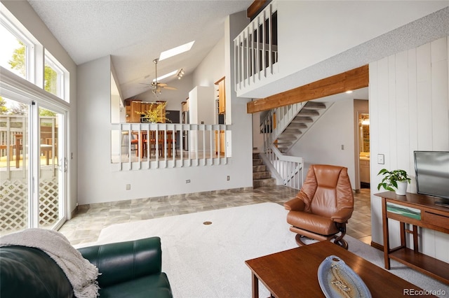10572 E Orchard Pl, Englewood, CO 80111 - living room featuring vaulted ceiling, stairs, a skylight, ceiling fan, and a textured ceiling