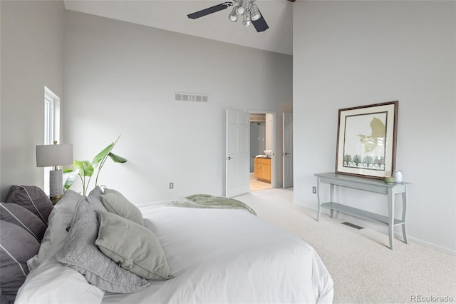 10572 E Orchard Pl, Englewood, CO 80111 - bedroom featuring a towering ceiling, light carpet, baseboards, connected bathroom, and ceiling fan