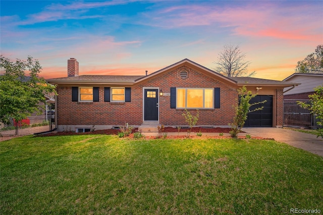 1607 Shasta Dr, Colorado Springs, CO 80910 - view of front of property featuring an attached garage, a chimney, brick siding, and driveway