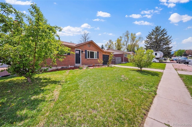 1607 Shasta Dr, Colorado Springs, CO 80910 - ranch-style home featuring brick siding, an attached garage, a front lawn, and driveway