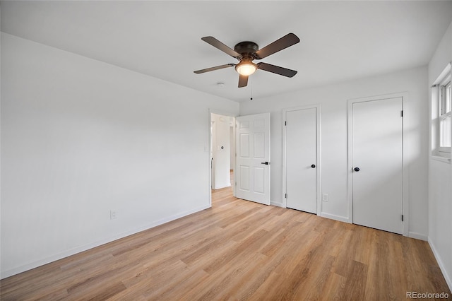 1607 Shasta Dr, Colorado Springs, CO 80910 - unfurnished bedroom with light wood-style floors, multiple closets, baseboards, and ceiling fan