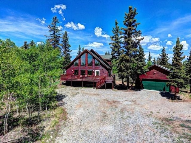 log-style house featuring an outbuilding and a garage