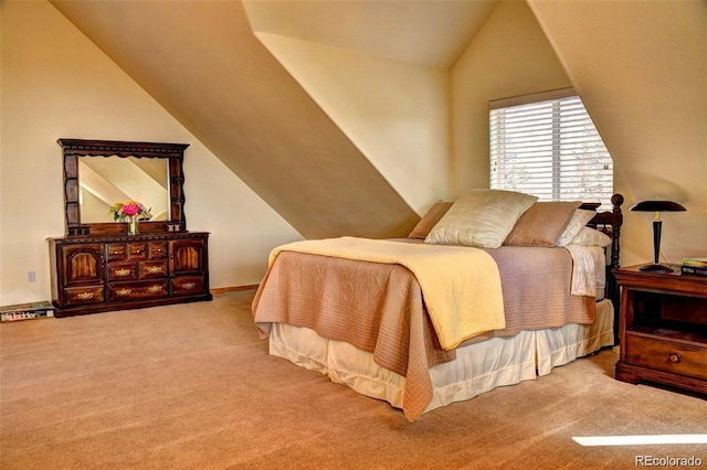 bedroom with carpet flooring and lofted ceiling