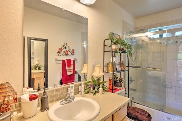 bathroom featuring vanity and combined bath / shower with glass door