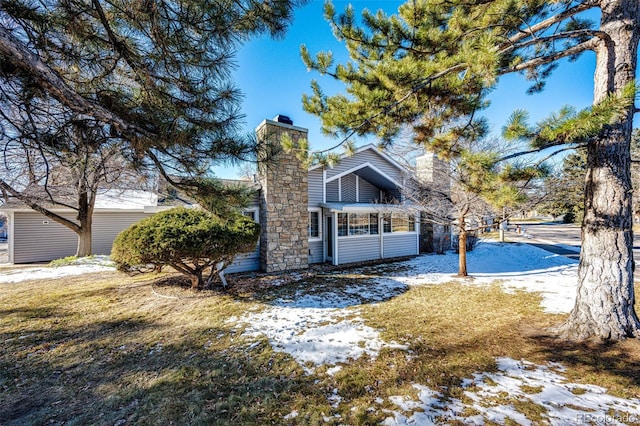 snow covered property with a lawn