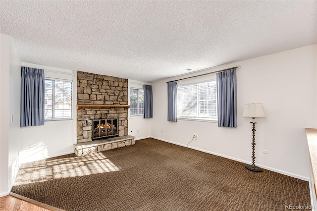 unfurnished living room featuring a fireplace, a textured ceiling, and carpet floors