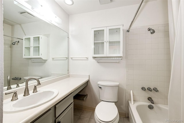 full bathroom with toilet, vanity, tile patterned floors, and tiled shower / bath