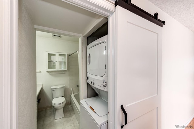 full bathroom with toilet, shower / bathing tub combination, stacked washer / dryer, and vanity