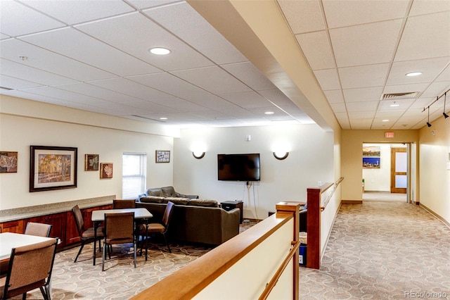 living room featuring a paneled ceiling