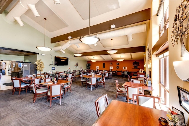 carpeted dining area with a high ceiling