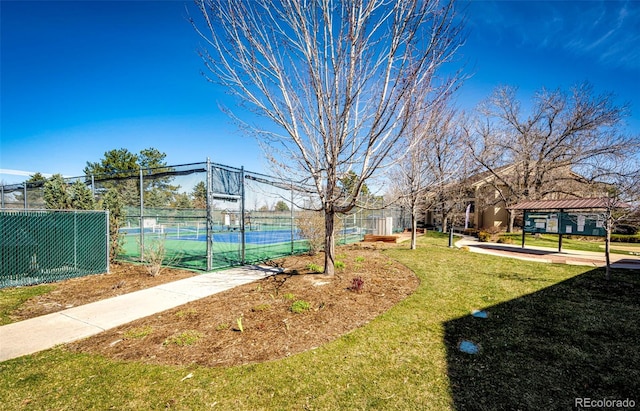 exterior space with a lawn and tennis court