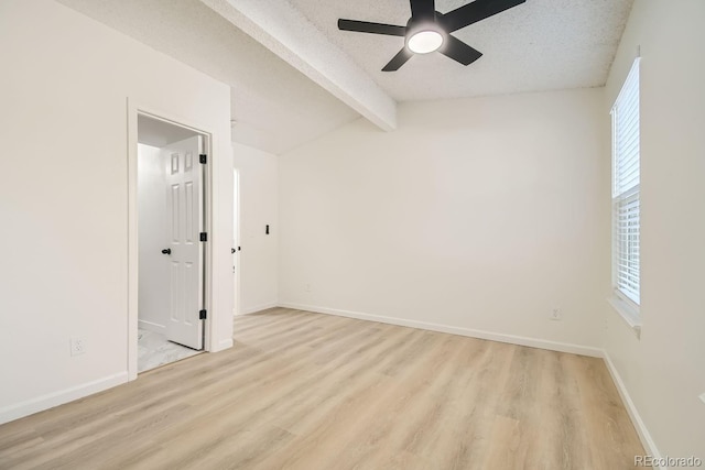 unfurnished room with lofted ceiling with beams, ceiling fan, light wood-type flooring, and a textured ceiling