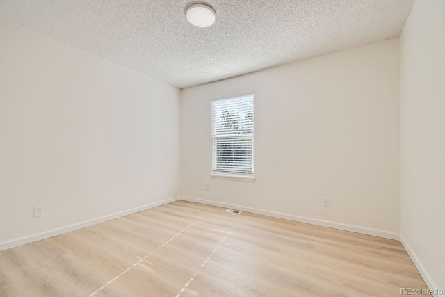 unfurnished room featuring a textured ceiling