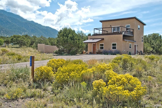 exterior space featuring a mountain view and a balcony