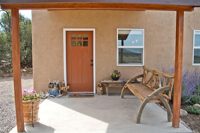 3421 Camino Del Rey, Crestone, CO 81131 - view of exterior entry with stucco siding and a patio
