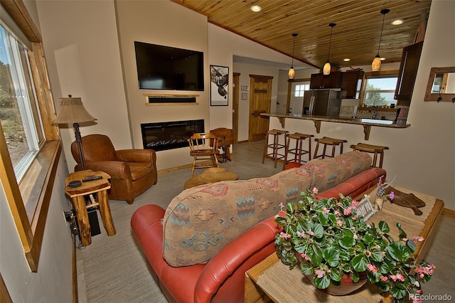 3421 Camino Del Rey, Crestone, CO 81131 - living room featuring wood ceiling, recessed lighting, a glass covered fireplace, lofted ceiling, and baseboards