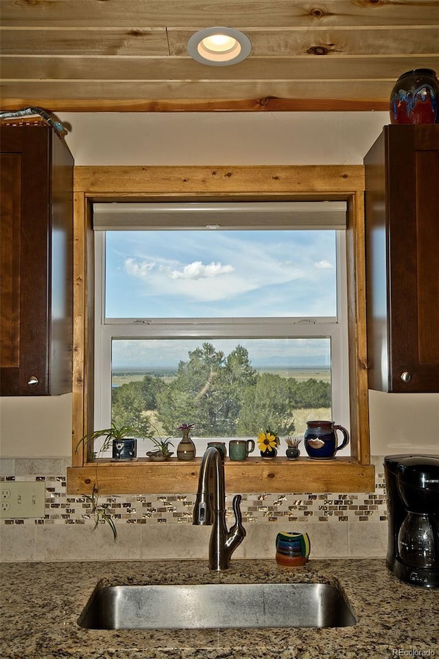 3421 Camino Del Rey, Crestone, CO 81131 - kitchen view of a sink, dark brown cabinets, decorative backsplash, and stone counters