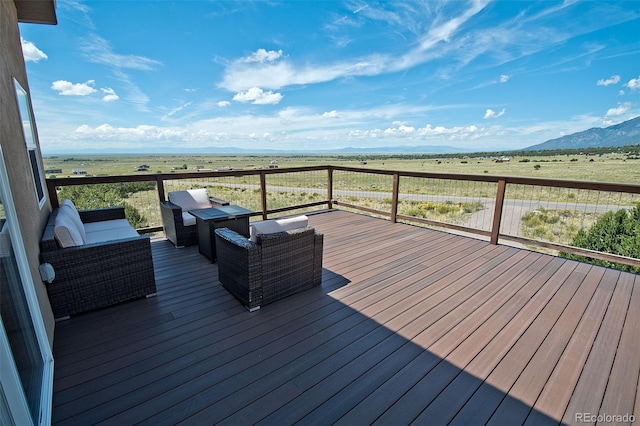 wooden deck featuring outdoor lounge area and a rural view