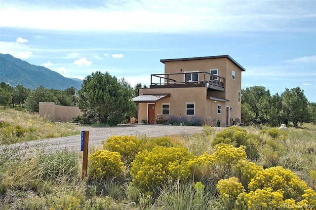 exterior space featuring a balcony and a mountain view