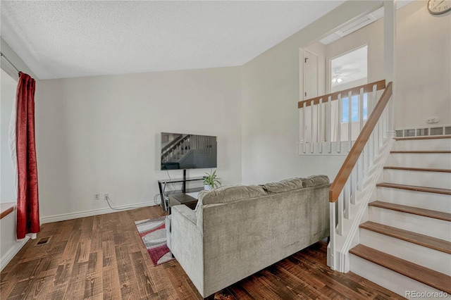 19140 E Milan Cir, Aurora, CO 80013 - living area with visible vents, baseboards, wood finished floors, and stairway