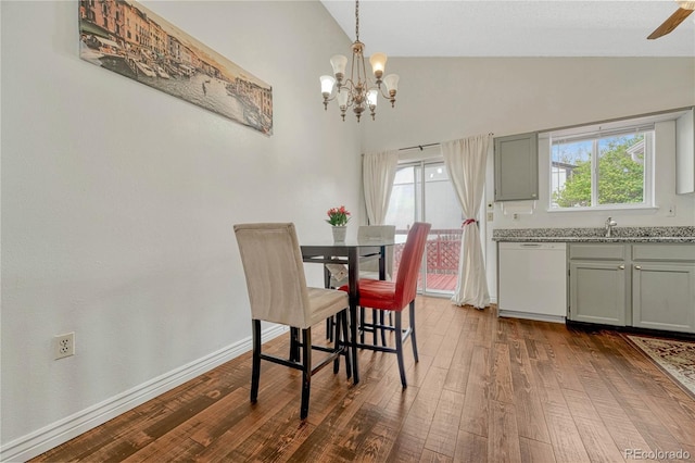 19140 E Milan Cir, Aurora, CO 80013 - dining room with dark wood finished floors, an inviting chandelier, high vaulted ceiling, and plenty of natural light