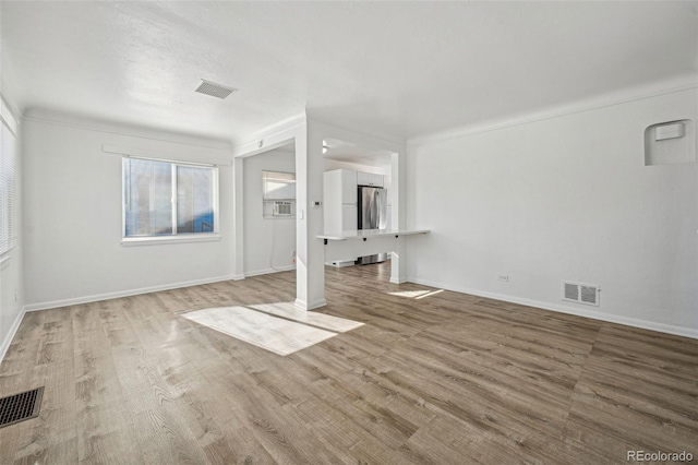 unfurnished living room featuring light hardwood / wood-style floors