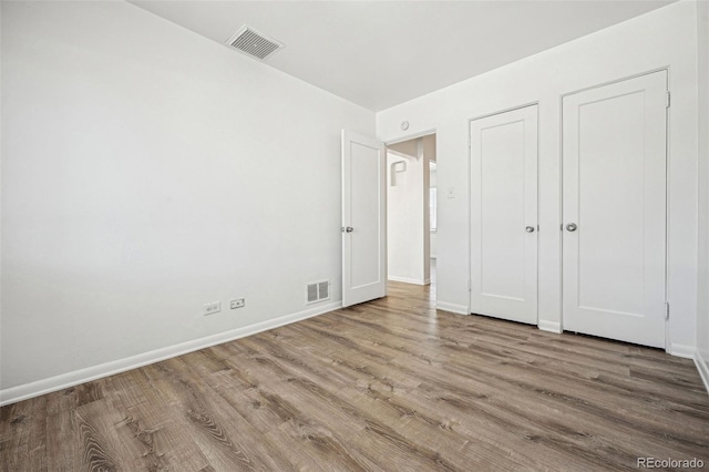 unfurnished bedroom featuring hardwood / wood-style flooring