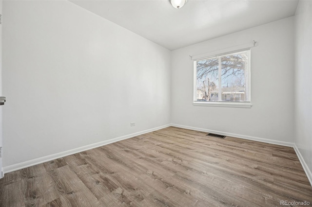 unfurnished room with light hardwood / wood-style floors