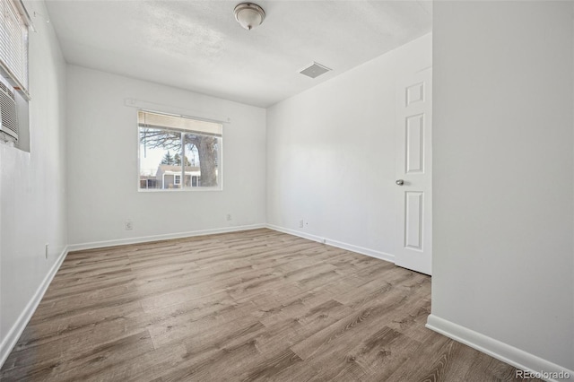 spare room featuring light hardwood / wood-style flooring