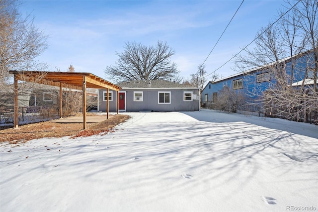 view of snow covered back of property