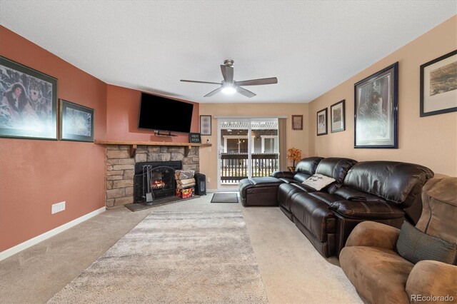 3482 S Eagle St Unit 102, Aurora, CO 80014 - carpeted living area with a ceiling fan, a fireplace, and baseboards