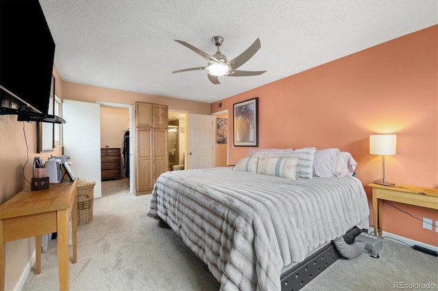 3482 S Eagle St Unit 102, Aurora, CO 80014 - bedroom featuring light colored carpet, ceiling fan, a textured ceiling, and ensuite bathroom