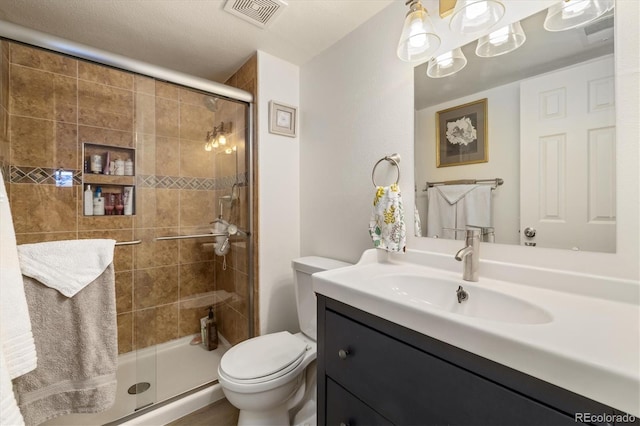 3482 S Eagle St Unit 102, Aurora, CO 80014 - bathroom featuring a shower stall, toilet, and vanity
