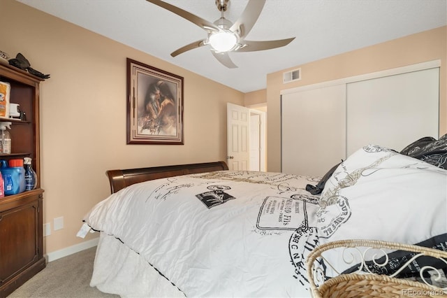 3482 S Eagle St Unit 102, Aurora, CO 80014 - bedroom with light carpet, a closet, baseboards, and a ceiling fan
