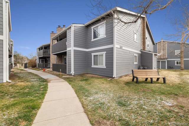 3482 S Eagle St Unit 102, Aurora, CO 80014 - view of property exterior with a chimney