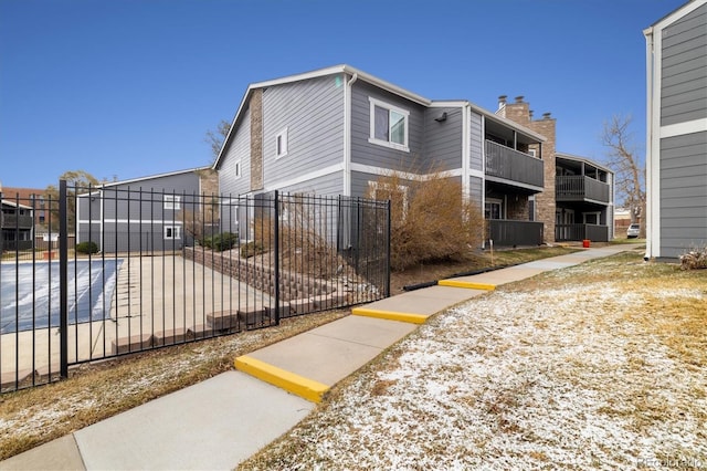 3482 S Eagle St Unit 102, Aurora, CO 80014 - view of front of house featuring fence and a chimney