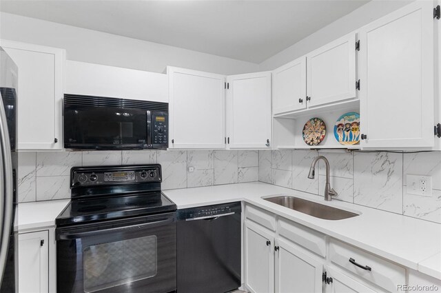 kitchen with black appliances, white cabinets, sink, and tasteful backsplash