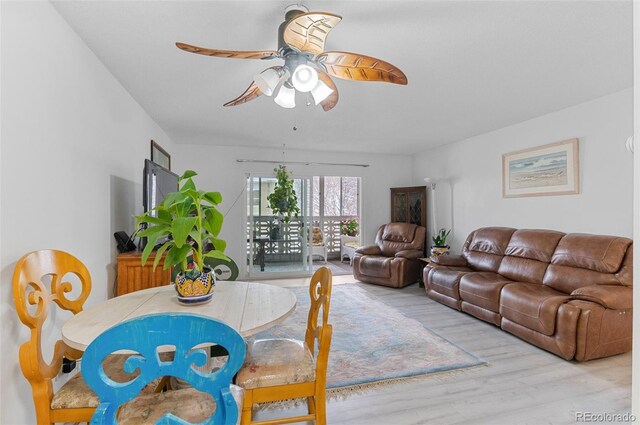 living room featuring ceiling fan and light hardwood / wood-style flooring