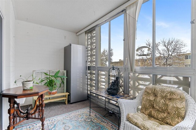 sitting room with carpet flooring and a textured ceiling